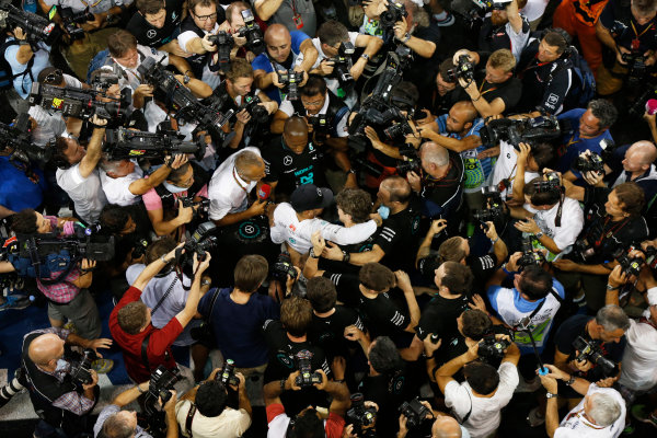 Yas Marina Circuit, Abu Dhabi, United Arab Emirates.
Sunday 23 November 2014.
Lewis Hamilton, Mercedes AMG, 1st Position, celebrates with his team.
World Copyright: Charles Coates/LAT Photographic.
ref: Digital Image _J5R7471