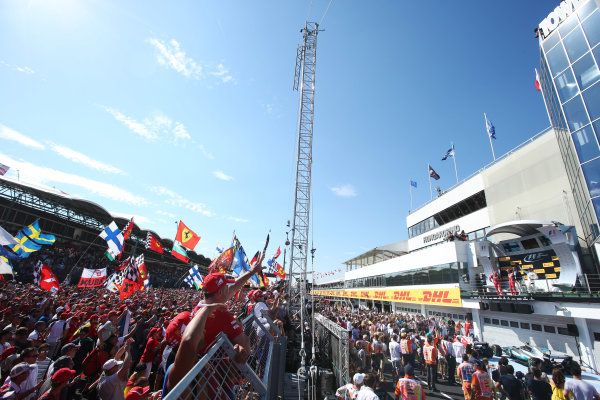 Hungaroring, Budapest, Hungary.
Sunday 30 July 2017.
Fans cheer for Sebastian Vettel, Ferrari, 1st Position, Kimi Raikkonen, Ferrari, 2nd Position, and Valtteri Bottas, Mercedes AMG, 3rd Position, on the podium.
World Copyright: Charles Coates}/LAT Images
ref: Digital Image AN7T9833 Hungaroring, Budapest, Hungary.
Sunday 30 July 2017.
Fans cheer for Sebastian Vettel, Ferrari, 1st Position, Kimi Raikkonen, Ferrari, 2nd Position, and Valtteri Bottas, Mercedes AMG, 3rd Position, on the podium.
World Copyright: Charles Coates}/LAT Images
ref: Digital Image AN7T9833