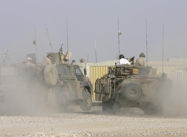 2007 Australian V8 Supercars.
Bahrain International Circuit. Sakhir, Bahrain.
2nd - 4th November. 
Kelly and Greg Murphy race against Craig Lowndes and Jason Bright  in a pair of armored troop carriers  during a visit to the Australian troops based at Tallil Airbase located approximately 310 kilometers Southeast of Baghdad. 
World Copyright: Mark Horsburgh/LAT Photographic. 
Ref: Digital Image V8-Drivers-IRAQ-6967